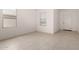 Bright, open living room with tile flooring, white walls and plenty of natural light at 36025 W Santa Clara Ave, Maricopa, AZ 85138