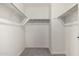 The walk-in closet includes bars for hanging clothes, offering ample storage at 36025 W Santa Clara Ave, Maricopa, AZ 85138