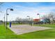 Outdoor recreational volleyball court with a net and playground in a grassy area at 42001 N Bridlewood Way, Phoenix, AZ 85086