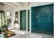 Bright bathroom with a blue tiled shower, unique decor, and a sunlit outdoor view at 4316 N 40Th St, Phoenix, AZ 85018