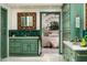 The bathroom features custom green cabinetry, a decorative mirror, and a doorway to the main bedroom at 4316 N 40Th St, Phoenix, AZ 85018