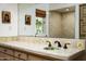 Well-lit bathroom vanity with large mirror and floral tile details at 4316 N 40Th St, Phoenix, AZ 85018
