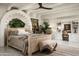 This stylish main bedroom boasts unique carved headboard, beam ceilings and custom cabinetry at 4316 N 40Th St, Phoenix, AZ 85018