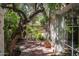 The beautiful outdoor space is landscaped with mature trees and a custom metal bench at 4316 N 40Th St, Phoenix, AZ 85018