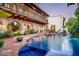 Beautiful backyard pool with a brick patio, arched columns, and lush landscaping, perfect for outdoor relaxation at 4316 N 40Th St, Phoenix, AZ 85018