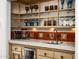 Stylish wet bar with a wine fridge, decorative tile backsplash, and open shelving at 4316 N 40Th St, Phoenix, AZ 85018