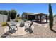 Backyard features a cozy fire pit area with pavers and a covered gazebo with outdoor dining at 500 W Nikita Dr, San Tan Valley, AZ 85140