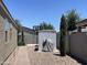 Backyard features a basketball court, storage shed, and manicured landscaping for outdoor recreation at 500 W Nikita Dr, San Tan Valley, AZ 85140