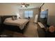 This bedroom features a ceiling fan, a barn door and a comfortable king-size bed at 500 W Nikita Dr, San Tan Valley, AZ 85140