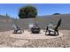 Outdoor fire pit with Adirondack chairs creates an inviting space for relaxation and gatherings at 500 W Nikita Dr, San Tan Valley, AZ 85140