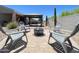 Backyard sitting area with pavers, a fire pit, and Adirondack chairs for outdoor enjoyment at 500 W Nikita Dr, San Tan Valley, AZ 85140