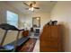 Bright office with a ceiling fan, desk, treadmill, and natural light at 500 W Nikita Dr, San Tan Valley, AZ 85140