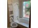 This bathroom features a shower, commode, and window above the bathtub at 6223 N 12Th St # 1, Phoenix, AZ 85014