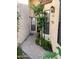 Charming walkway to the front door framed by plants and neutral walls at 6223 N 12Th St # 1, Phoenix, AZ 85014