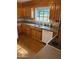 Kitchen featuring wood cabinets, laminate floors, and stainless steel sink under window at 6223 N 12Th St # 1, Phoenix, AZ 85014