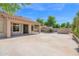 Spacious concrete patio and block wall fenced yard with covered veranda and lush landscaping at 8354 W Marlette Ave, Glendale, AZ 85305