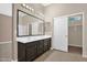 Bathroom featuring double sinks and a large mirror at 8354 W Marlette Ave, Glendale, AZ 85305