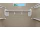 Walk-in closet with multiple levels of shelving and clothing rods at 8354 W Marlette Ave, Glendale, AZ 85305