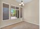 Dining area with tiled floors, three panel window and chandelier at 8354 W Marlette Ave, Glendale, AZ 85305