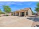 Exterior facade of home featuring a spacious concrete driveway, desert landscaping, and covered porch entry at 8354 W Marlette Ave, Glendale, AZ 85305