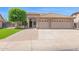 Charming single-story home featuring a tile roof, lush lawn, mature tree, and a two-car garage at 8354 W Marlette Ave, Glendale, AZ 85305