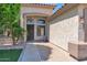 Home featuring covered front door and walkway with brick accents and desert landscaping at 8354 W Marlette Ave, Glendale, AZ 85305