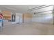 Spacious garage with room for storage, equipped with shelving, water heater, and ample open space at 8354 W Marlette Ave, Glendale, AZ 85305
