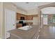 Kitchen featuring a center island, wood cabinetry, and modern appliances at 8354 W Marlette Ave, Glendale, AZ 85305