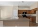 Kitchen island with sink with wood cabinets and modern appliances at 8354 W Marlette Ave, Glendale, AZ 85305