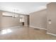 Open-concept living room with tile flooring, neutral walls, and arched doorways leading to other spaces at 8354 W Marlette Ave, Glendale, AZ 85305