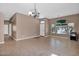Spacious living room with tile flooring, arched windows, and a decorative chandelier at 8354 W Marlette Ave, Glendale, AZ 85305