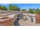 An outdoor kitchen featuring a grill, cooking space, and bar seating, perfect for entertaining at 8354 W Marlette Ave, Glendale, AZ 85305