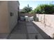 Enclosed backyard with stone walkway, desert landscaping, and outdoor furniture covered for protection at 9728 N 106Th Pl # 154, Scottsdale, AZ 85258