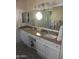 The bathroom boasts granite countertops, dual sinks, and a large mirror at 9728 N 106Th Pl # 154, Scottsdale, AZ 85258