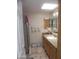 Well-lit bathroom features granite countertops, a framed mirror, and a tiled shower at 9728 N 106Th Pl # 154, Scottsdale, AZ 85258