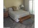 This bedroom features an ornate bed frame, neutral tones, and a wooden bench at 9728 N 106Th Pl # 154, Scottsdale, AZ 85258