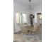 Bright dining area featuring a glass table, rattan chairs, and natural light at 9728 N 106Th Pl # 154, Scottsdale, AZ 85258