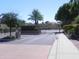Community entrance gate surrounded by mature landscaping and lush greenery at 9728 N 106Th Pl # 154, Scottsdale, AZ 85258