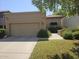 Well-maintained home exterior with a spacious two-car garage, mature landscaping, and a tiled roof at 9728 N 106Th Pl # 154, Scottsdale, AZ 85258