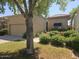 Charming home exterior with a two-car garage, manicured landscaping, and a tiled roof at 9728 N 106Th Pl # 154, Scottsdale, AZ 85258