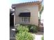 This home features a front window, a black awning, and manicured landscaping at 9728 N 106Th Pl # 154, Scottsdale, AZ 85258