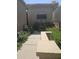 Charming front walkway leading to the home's entrance, framed by lush greenery and desert landscaping at 9728 N 106Th Pl # 154, Scottsdale, AZ 85258
