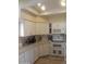 Well-lit kitchen with white cabinets, modern appliances, and ample counter space at 9728 N 106Th Pl # 154, Scottsdale, AZ 85258