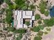 An aerial view of a modern home featuring a private pool, spa, and multiple outdoor living spaces at 10119 E Winter Sun Dr, Scottsdale, AZ 85262