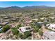 Expansive aerial view of a desert community showcasing custom homes and scenic mountain views at 10119 E Winter Sun Dr, Scottsdale, AZ 85262