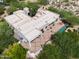 Aerial view of the home with an in-ground pool, hot tub, and expansive patio with seating at 10119 E Winter Sun Dr, Scottsdale, AZ 85262