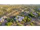 Stunning aerial shot of a home nestled in lush desert landscaping, with mountain views at 10119 E Winter Sun Dr, Scottsdale, AZ 85262