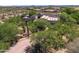 Aerial view of the home showing a circular driveway and lush landscaping at 10119 E Winter Sun Dr, Scottsdale, AZ 85262