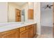Bathroom features a vanity with wood cabinets, a white countertop and a mirror at 10119 E Winter Sun Dr, Scottsdale, AZ 85262