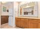 Bathroom featuring a vanity, a stackable washer and dryer, and wooden cabinets at 10119 E Winter Sun Dr, Scottsdale, AZ 85262
